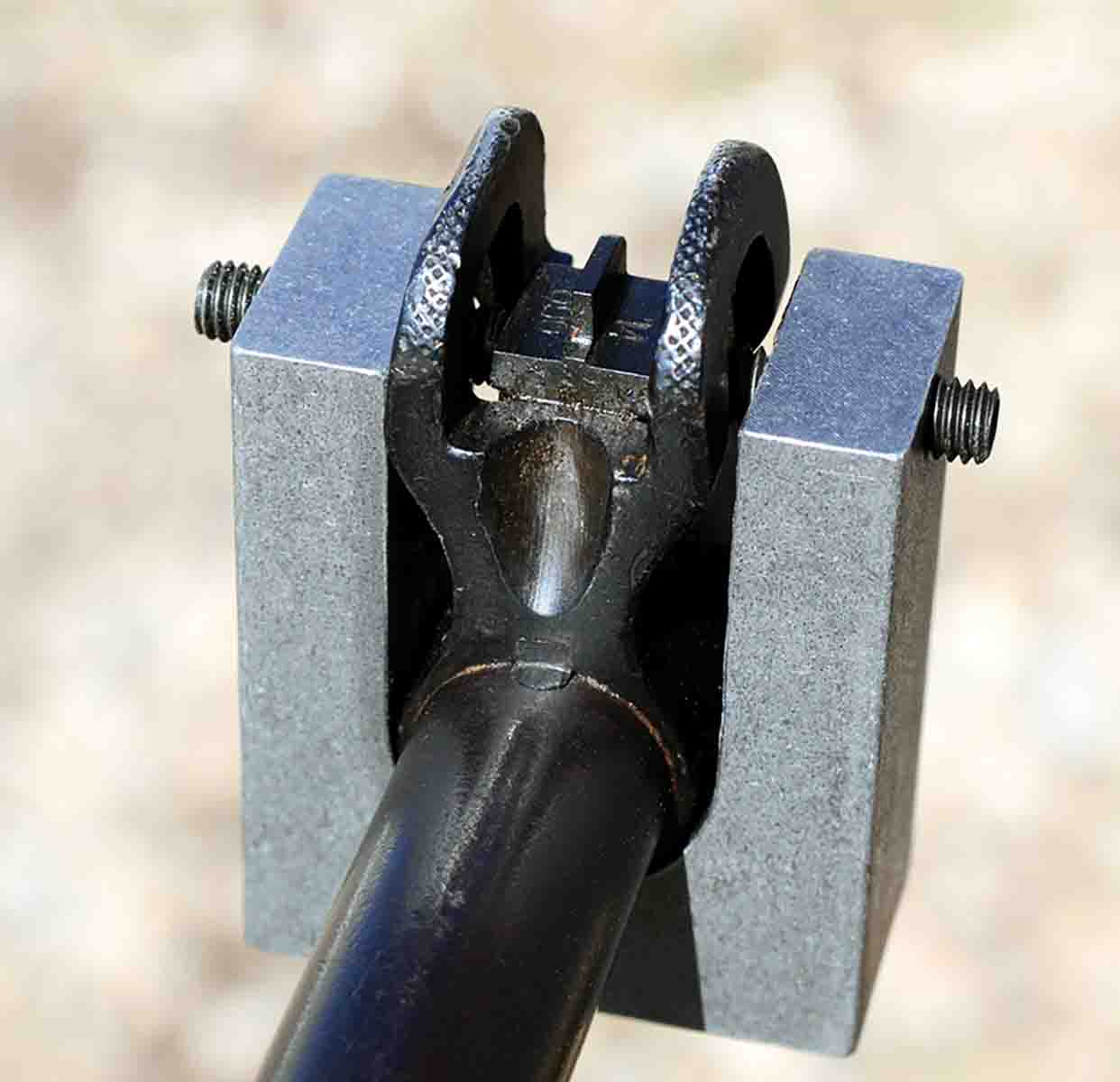 Formerly a part of a military armorer’s kit, this block fits on U.S. Model 1917 barrels so that front sight blades can be moved precisely by the screws.